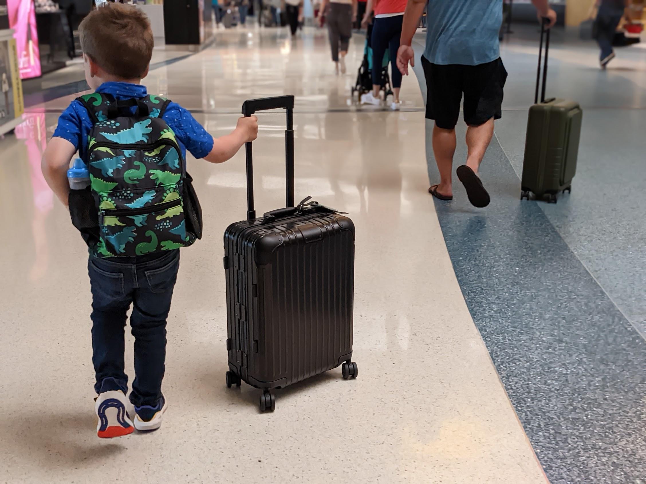a child pulling a suitcase
