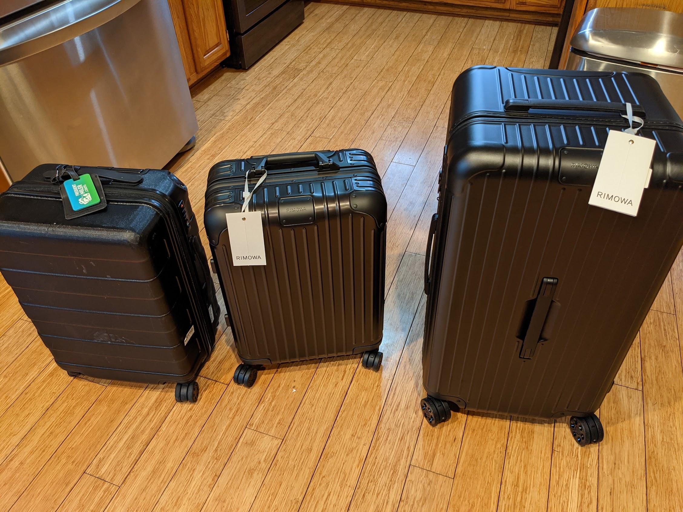 a group of luggage on a wood floor