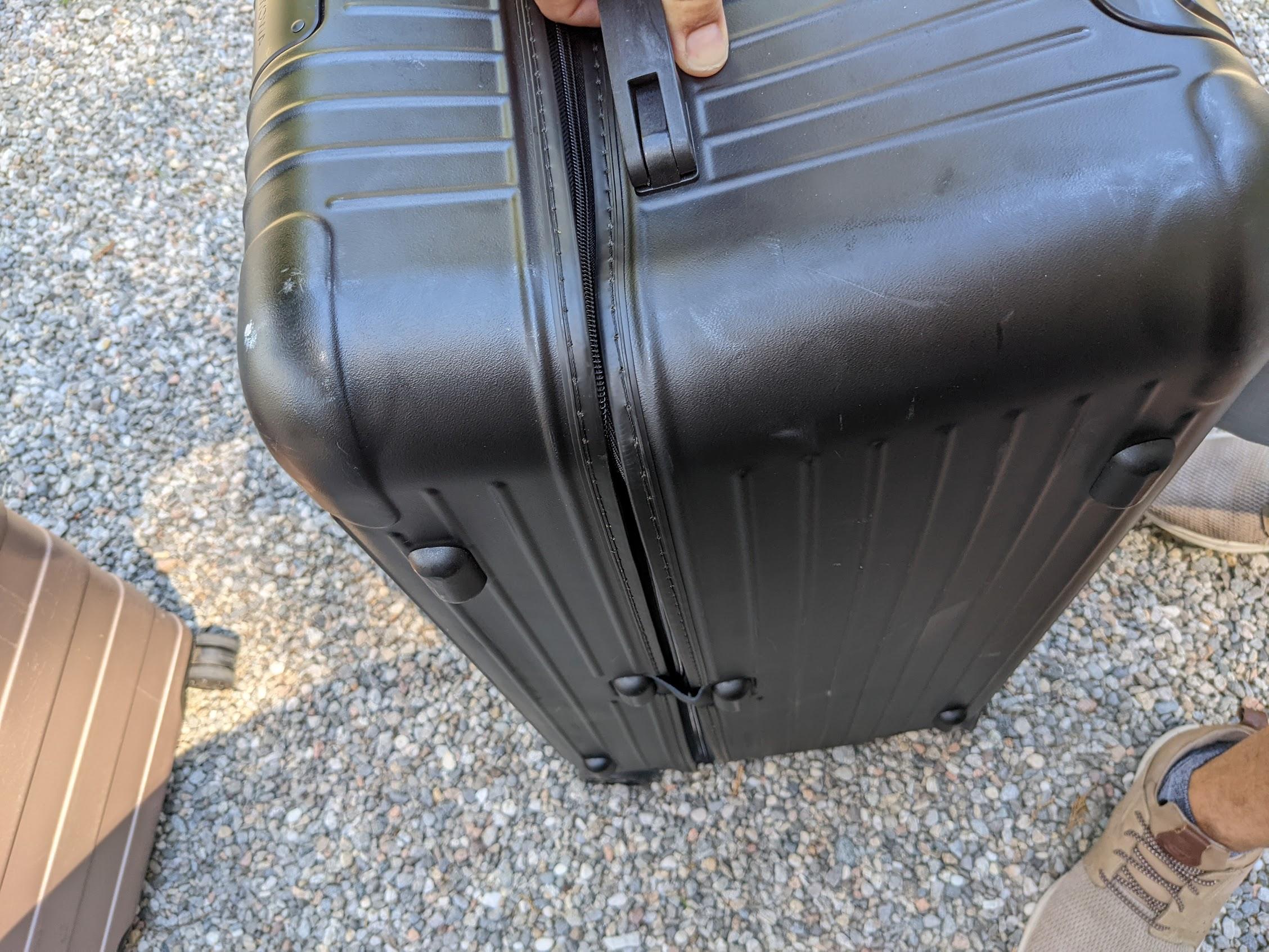 a person holding a black suitcase