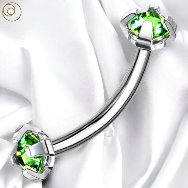 A green gem eyebrow bar pictured against a white fabric background.
