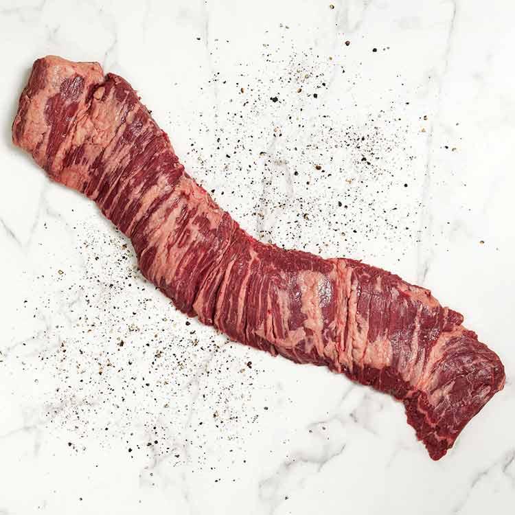 seared skirt steak resting on a cutting board