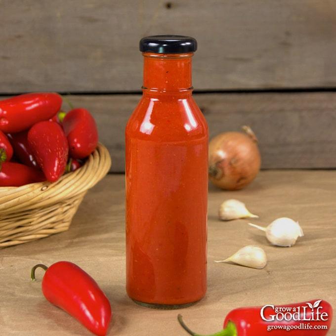 bottle of roasted red jalapeno hot sauce on a table