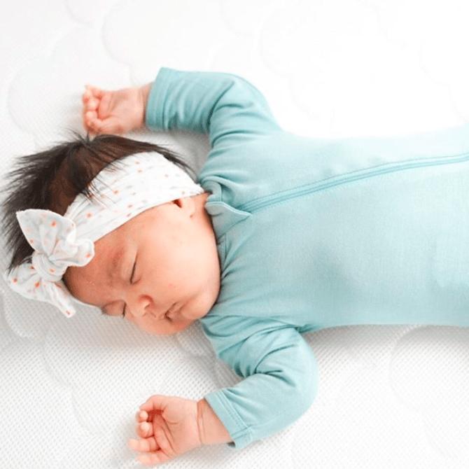 Sleeping baby who has parents that know when to stop using sleep sack