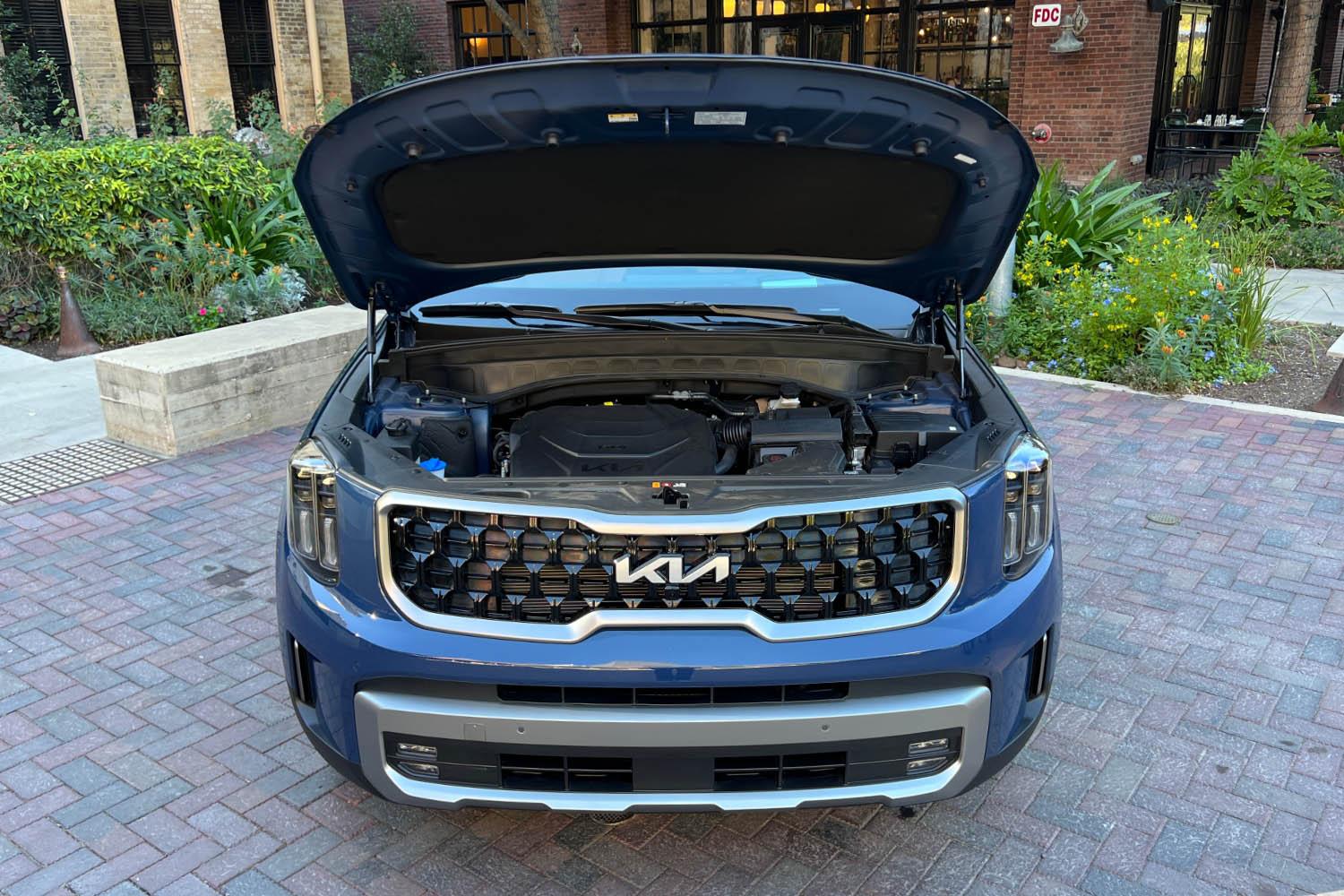 2023 Kia Telluride with hood up, displaying engine bay.