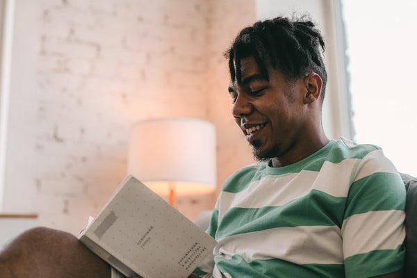a man with dreads reading a book