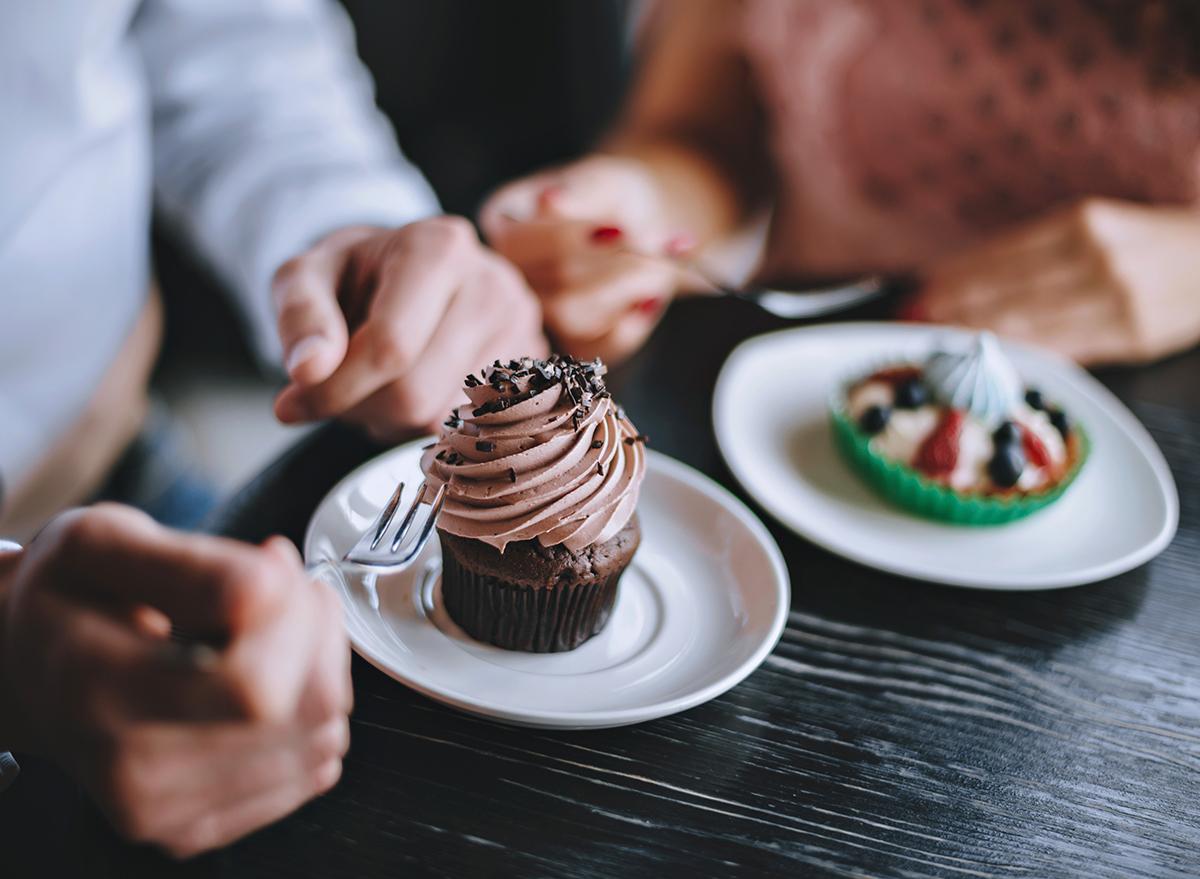 man and woman eating dessert