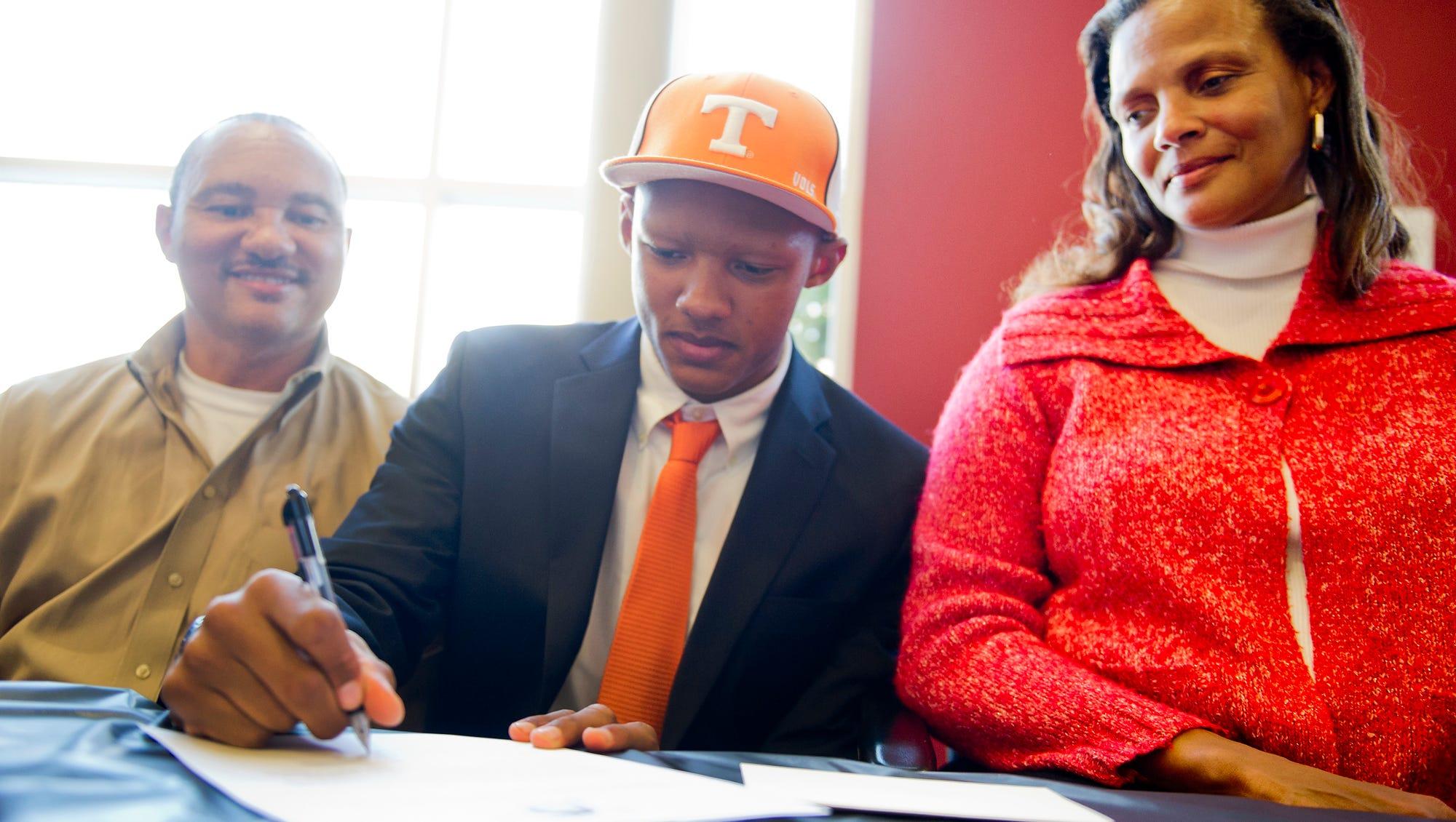 Seated between his father, Robert, and mother, Stephanie, Joshua Dobbs signs his letter of intent to play football at Tennessee on Feb. 6, 2013.
