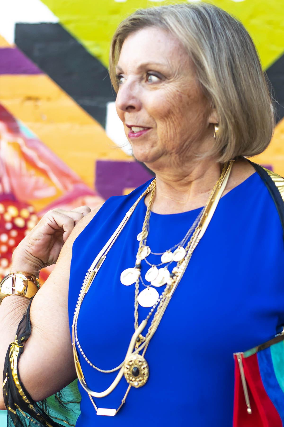 Gold necklaces as a pop on royal blue top