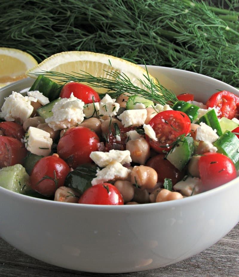 Chickpea Tomato Cucumber Salad whips up in under 10 minutes with tasty flavors and a light lemon dressing! Great side dish or lunch.