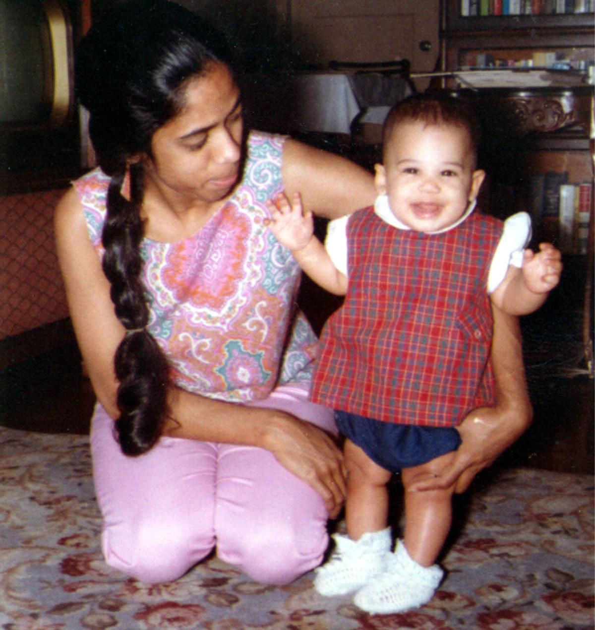 A jubilant Harris embraces a smiling young girl in a purple t-shirt