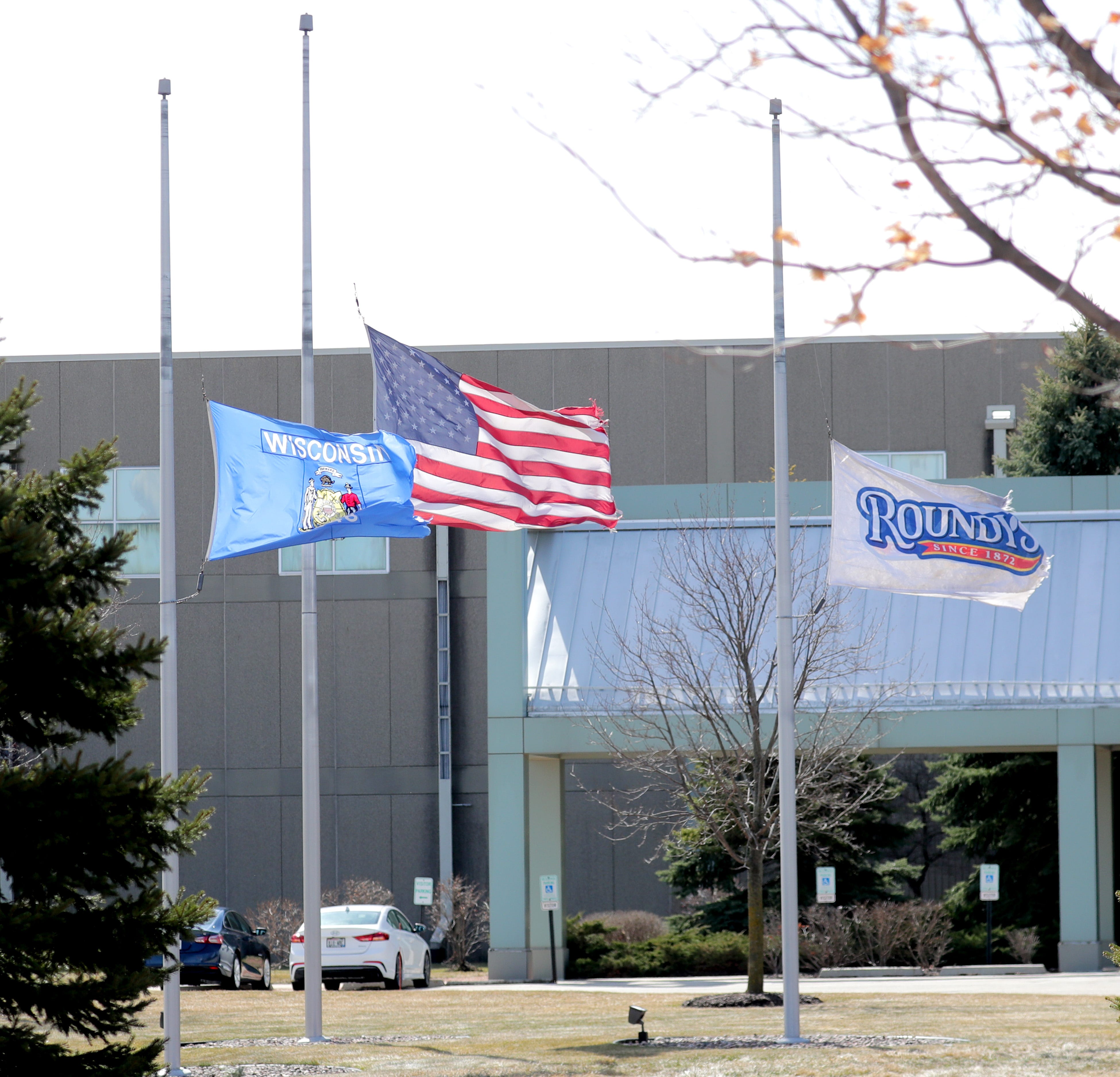 The flags fly at half-staff at the Roundy